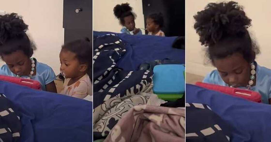 Little girl feeds brother, kind big sister Little girl feeds brother, kind big sister