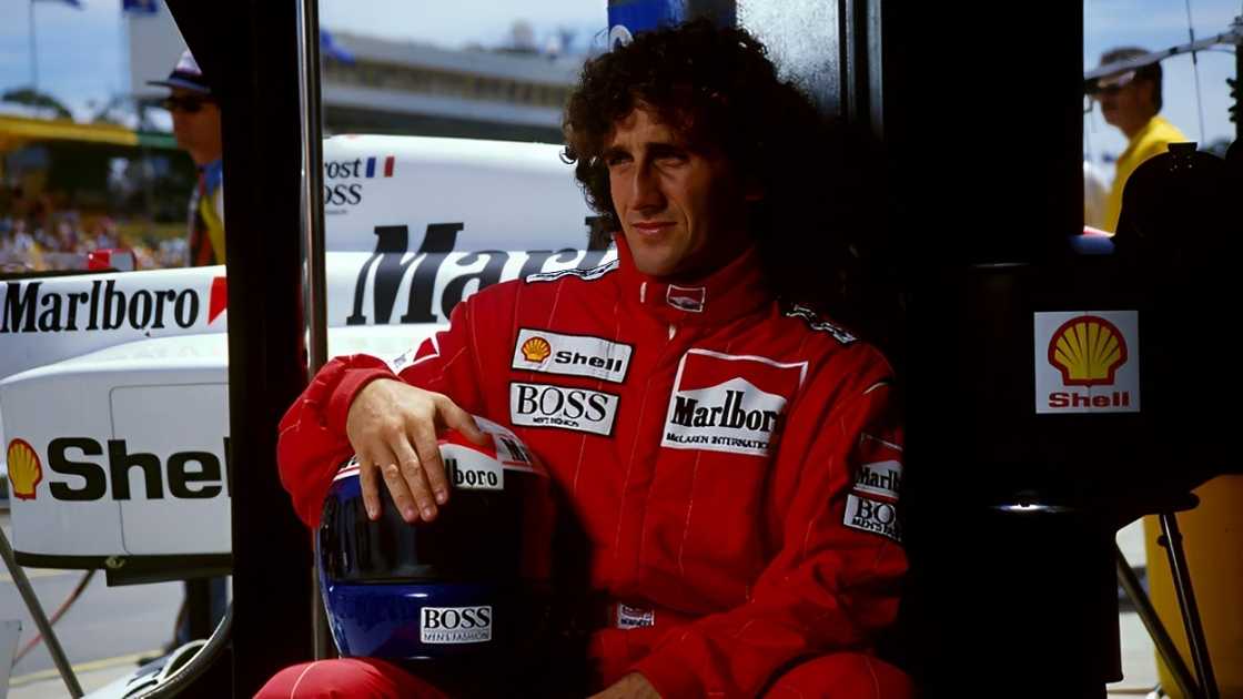 Alain Prost, pictured in the paddock wearing his Marlboro-branded racing overalls and helmet. Alain Prost, pictured in the paddock wearing his Marlboro-branded racing overalls and helmet.