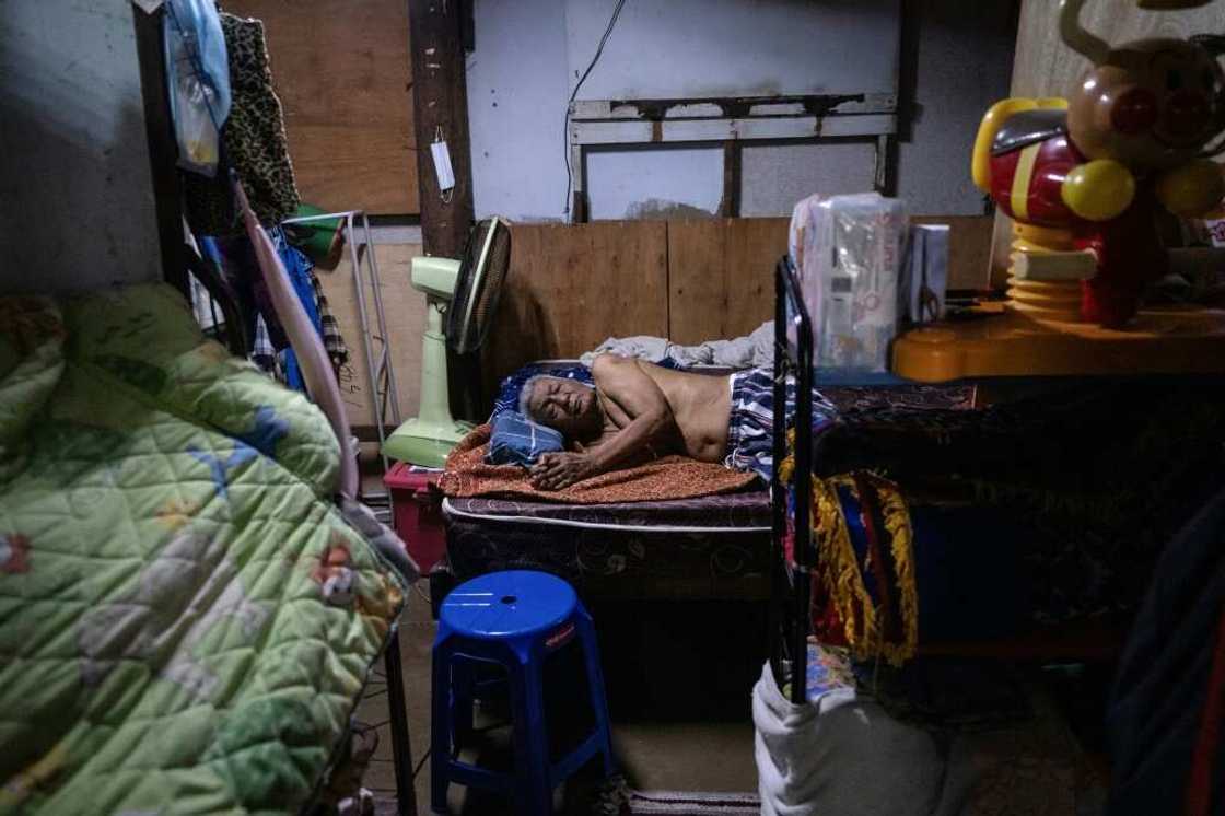 Arj Keawwilat, 88, is bedridden after recently having a fall trying to get to the bathroom. His daughter Orn has to juggle caring for him and running a small general store to support her household Arj Keawwilat, 88, is bedridden after recently having a fall trying to get to the bathroom. His daughter Orn has to juggle caring for him and running a small general store to support her household