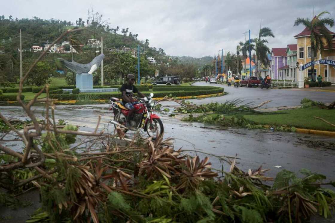 A man rides his motorbike past fallen branches after the passage of Hurricane Fiona, in Samana, Dominican Republic A man rides his motorbike past fallen branches after the passage of Hurricane Fiona, in Samana, Dominican Republic
