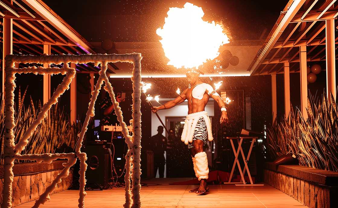 A performer breathes out a large plume of fire from their mouth at Zazu Bar. A performer breathes out a large plume of fire from their mouth at Zazu Bar.