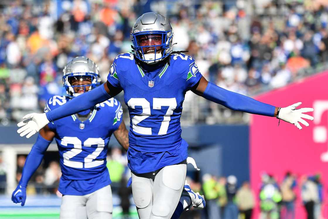 Riq Woolen celebrates after an interception in the second quarter of a game against the Cleveland Browns