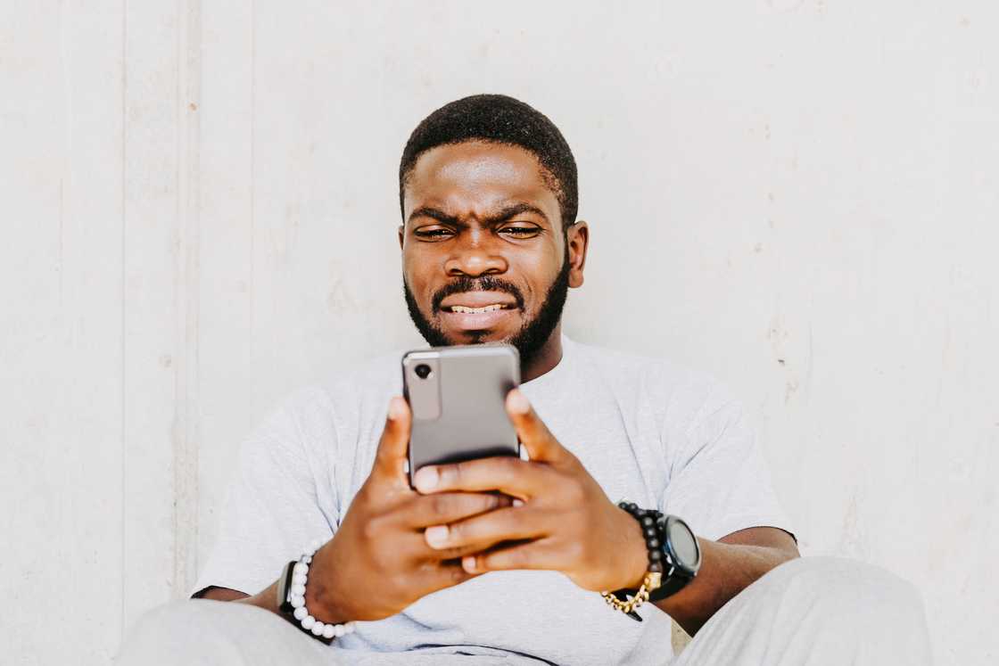 A young man using his smartphone. A young man using his smartphone.