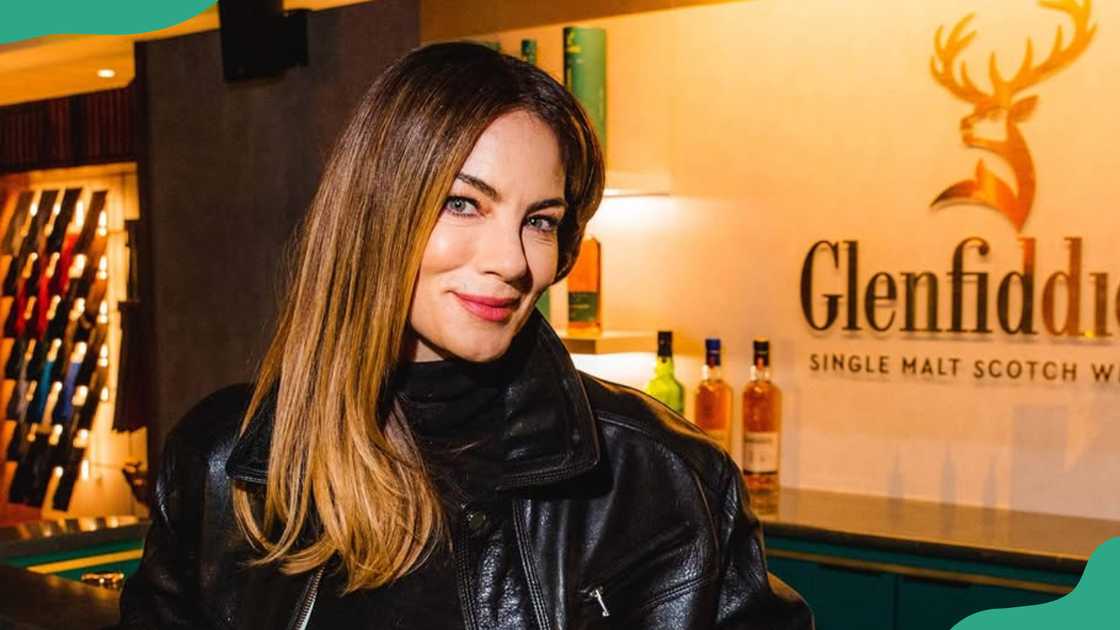 Michelle Monaghan smiles as she poses next to a hotel reception Michelle Monaghan smiles as she poses next to a hotel reception