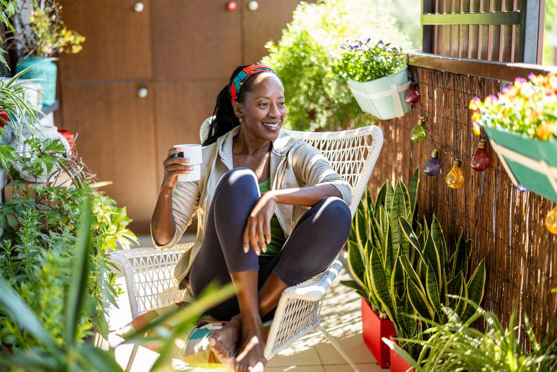 A lady on the balcony holding her drink