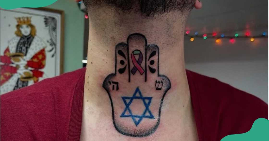 A Hand of Hamsa tattoo on the throat. A Hand of Hamsa tattoo on the throat.