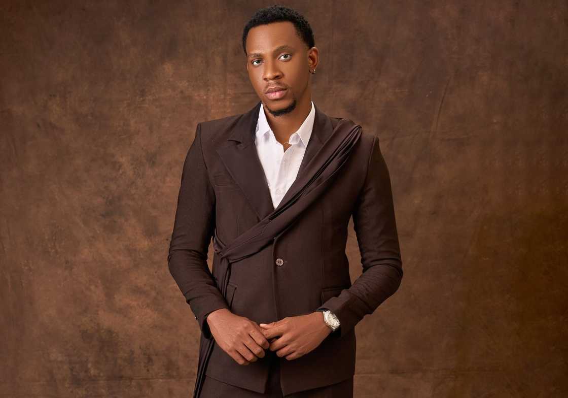 Muudumbari Pop-Yornwin poses in a brown suit