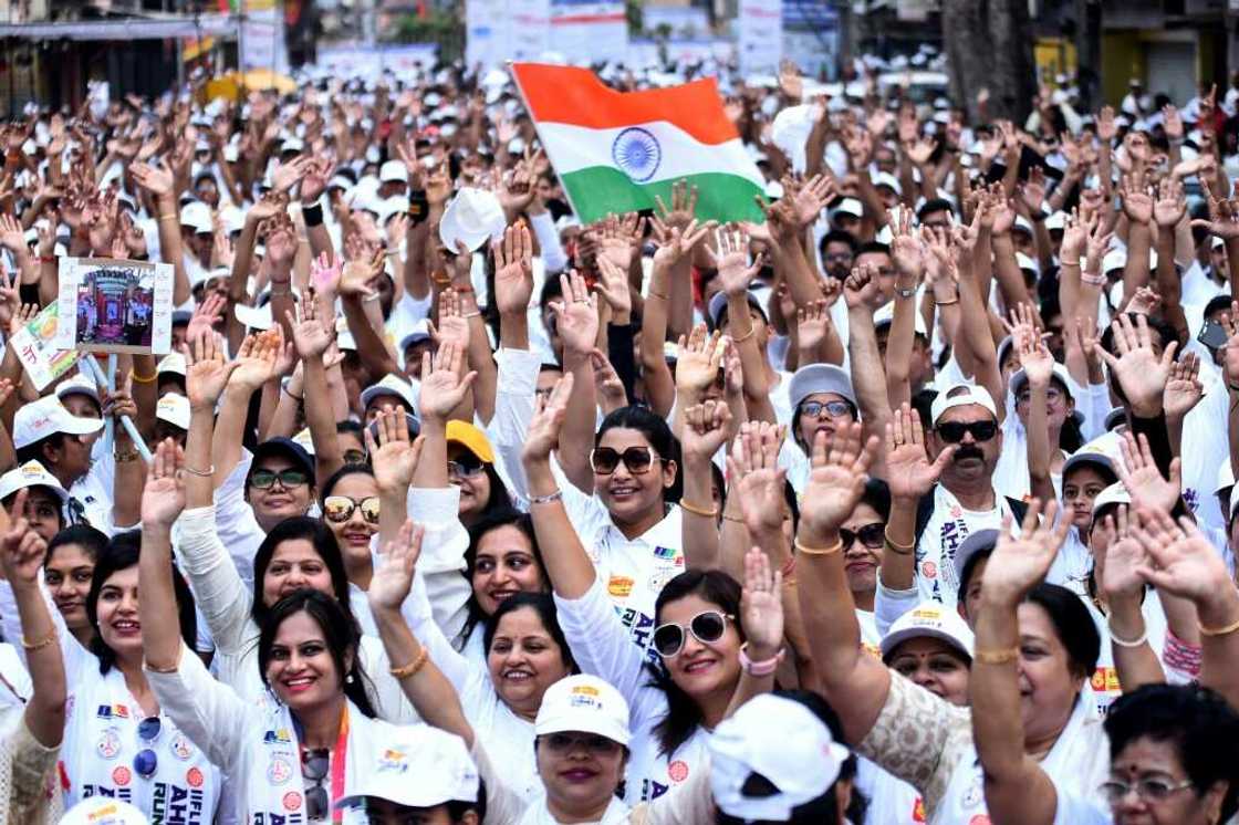 People wave India's national flag as they take part in 'Ahimsa Run' (nonviolence run) during a campaign to create awareness for citizens to vote, ahead of the country's upcoming national elections People wave India's national flag as they take part in 'Ahimsa Run' (nonviolence run) during a campaign to create awareness for citizens to vote, ahead of the country's upcoming national elections