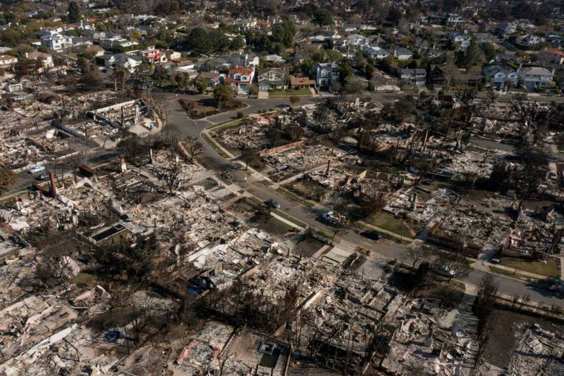 An aerial image shows homes damaged and destroyed by the Palisades Fire in the Pacific Palisades neighborhood of Los Angeles, California, on January 29, 2025.