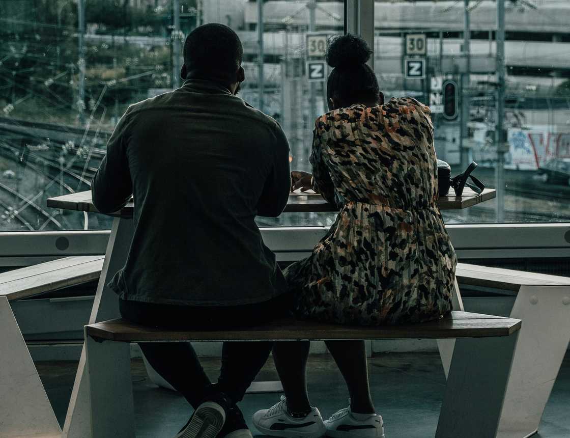 A couple sitting on a balcony