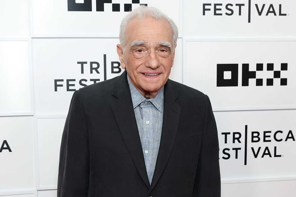 Martin Scorsese in a black blazer over a light blue shirt, smiling in front of a Tribeca Festival step-and-repeat backdrop. Martin Scorsese in a black blazer over a light blue shirt, smiling in front of a Tribeca Festival step-and-repeat backdrop.