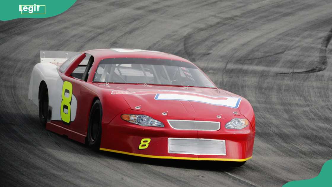 A late model stock car racing on an oval track A late model stock car racing on an oval track
