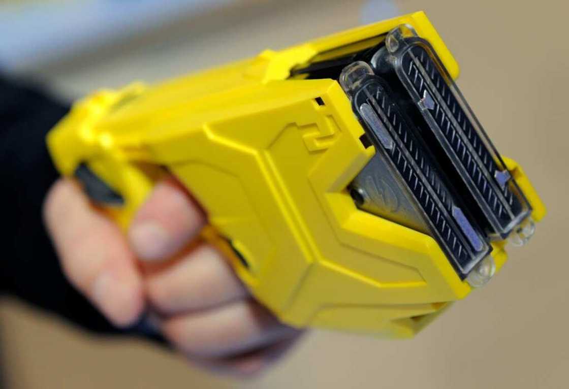 The non-lethal taser sends out an electric pulse through a web of mini-electric cables The non-lethal taser sends out an electric pulse through a web of mini-electric cables