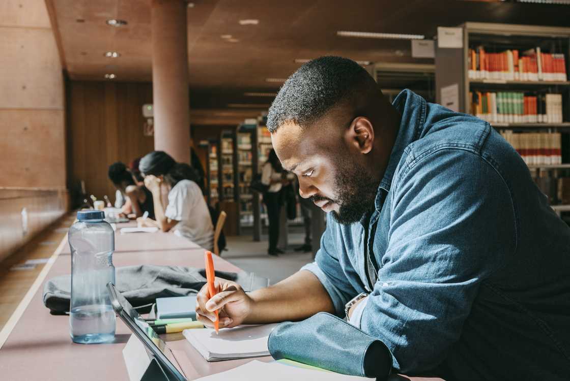 A student taking notes in a library