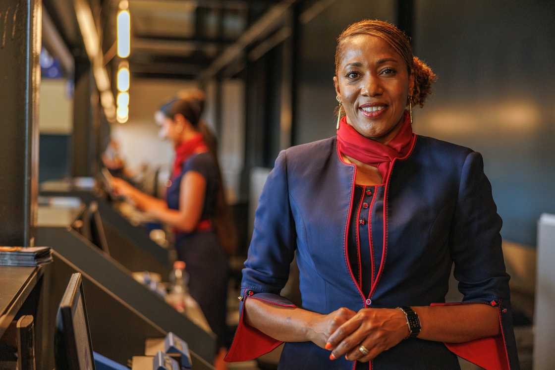 Airport check-in counter with the stewardess smiling.