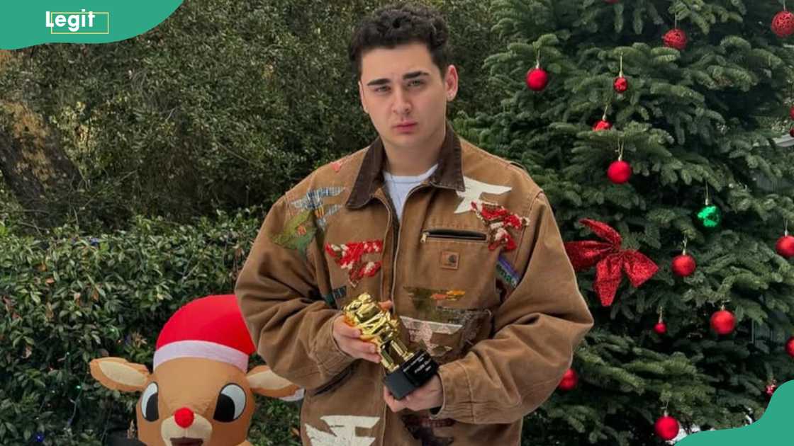 FaZe Lacy poses for a photo next to a Christmas tree FaZe Lacy poses for a photo next to a Christmas tree