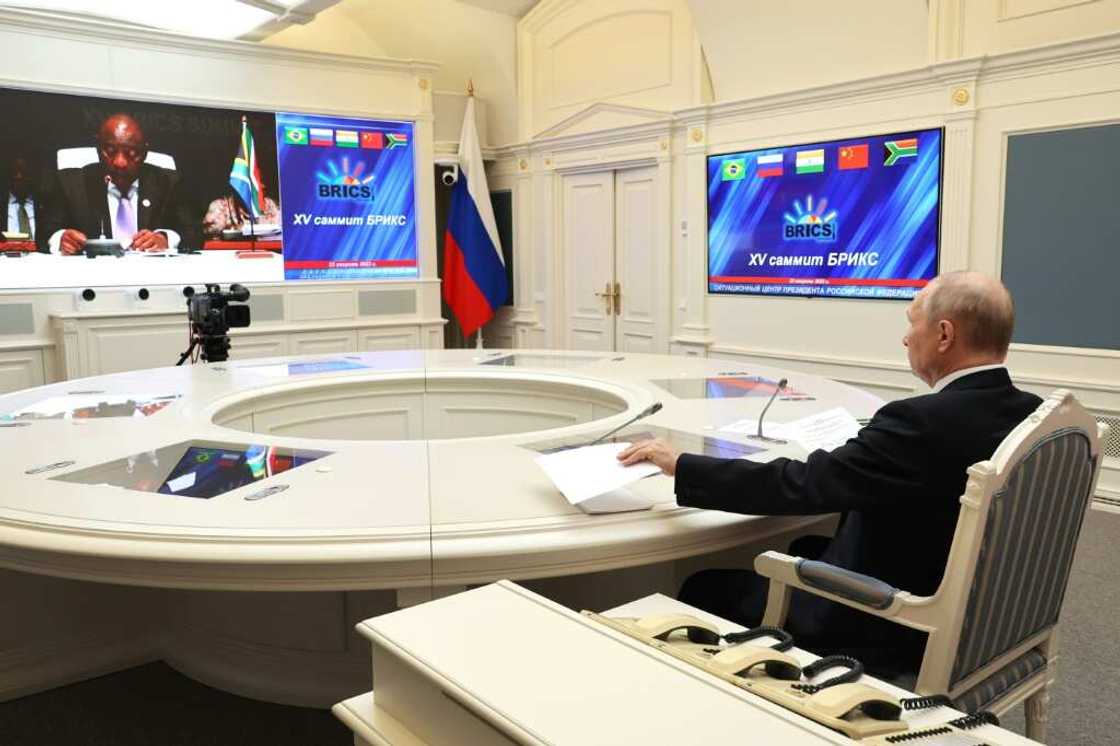 Putin, seen here in a picture distributed by the Russian news agency Sputnik, joined the summit by video link Putin, seen here in a picture distributed by the Russian news agency Sputnik, joined the summit by video link