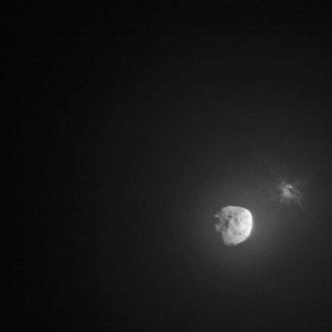 This handout picture obtained by the Italian Space Agency’s LICIACube shows the intentional collision of NASA's Double Asteroid Redirection Test (DART) mission with its target asteroid Dimorphos