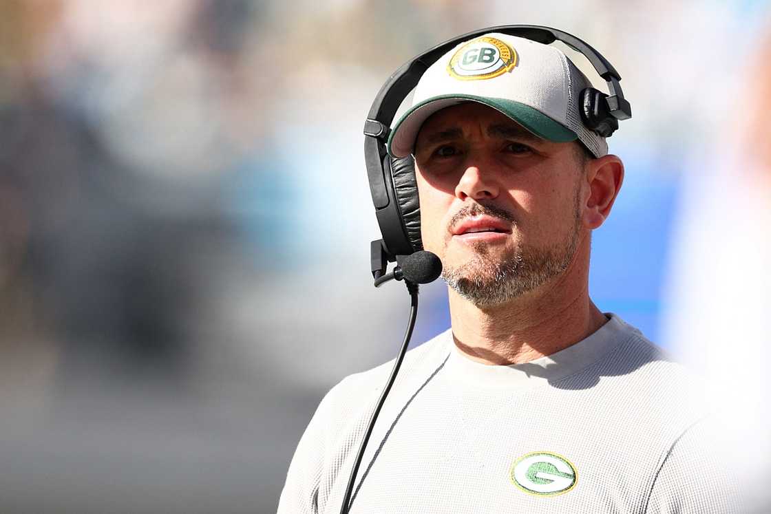 Matt LaFleur is pictured in a white outfit and a headset. Matt LaFleur is pictured in a white outfit and a headset.