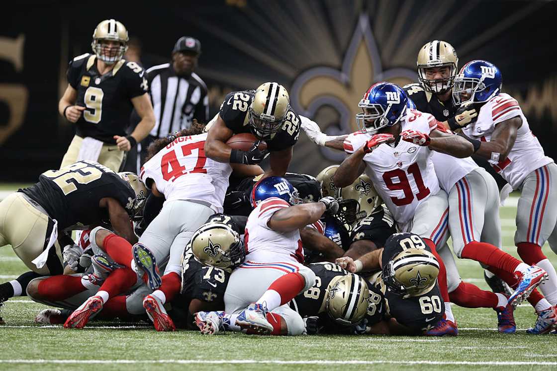 Mark Ingram #22 of the New Orleans Saints leaps over the pile at the Mercedes-Benz Superdome