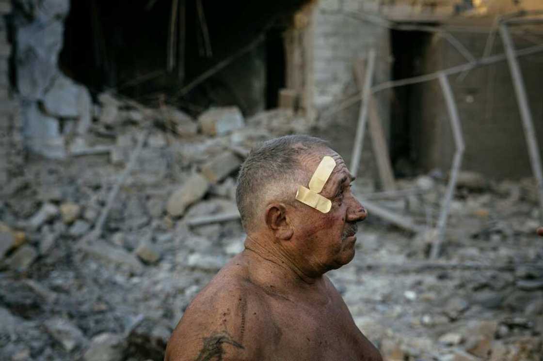 Oleksandr Shulga looks at his destroyed house following a missile strike in Mykolaiv on August 29, 2022