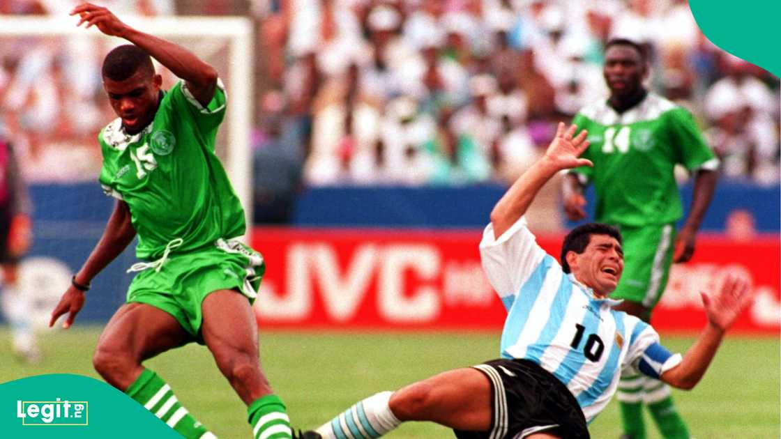 Nigeria's Sunday Oliseh strips the ball away from a falling Diego Maradona during the FIFA World Cup 1994 Group D match between Argentina and Nigeria. Photo by Ben Radford