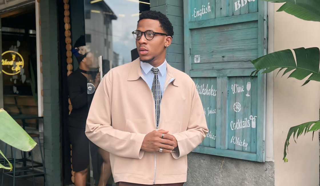 Barry from BBNaija poses standing outside a restaurant. Barry from BBNaija poses standing outside a restaurant.