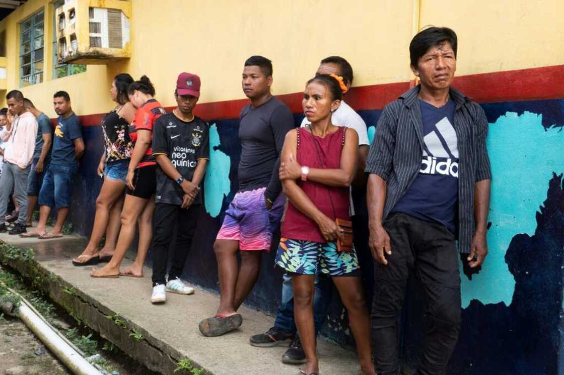 Indigenous Ticuna voters line up to cast their ballots Indigenous Ticuna voters line up to cast their ballots