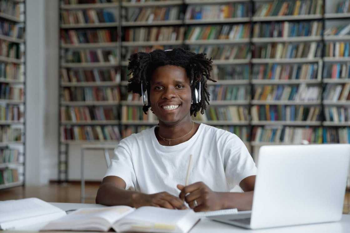 A guy student sit at table in library