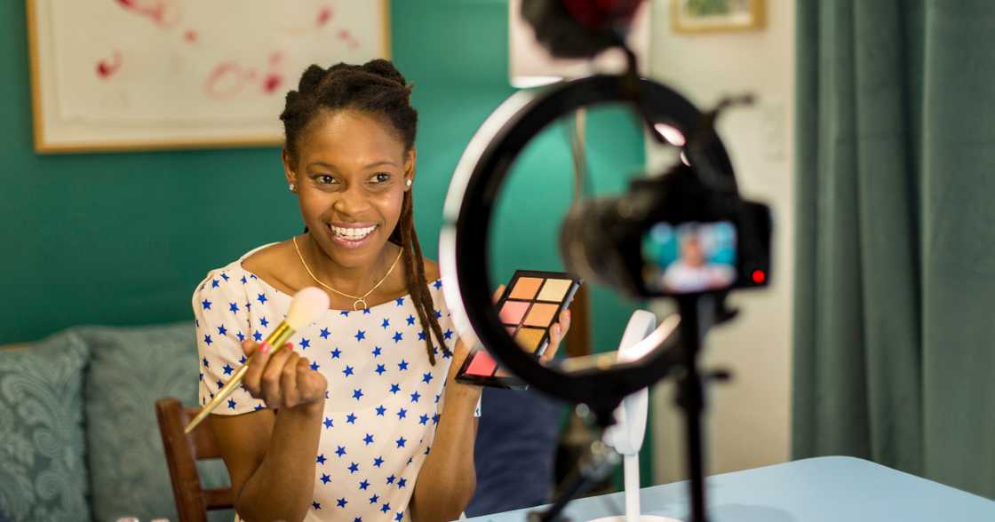A young woman films a beauty and makeup vlog A young woman films a beauty and makeup vlog