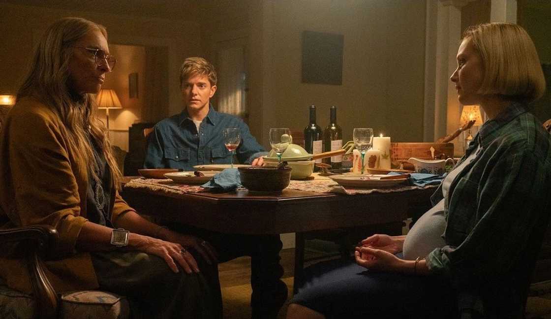 Evelyn Wade, Alex Dempsey and his wife, Laura Redman have a conversation on a dinner table.