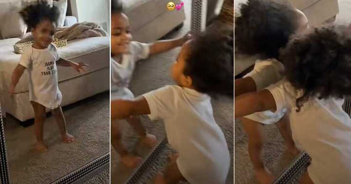 Little girl admires her reflection