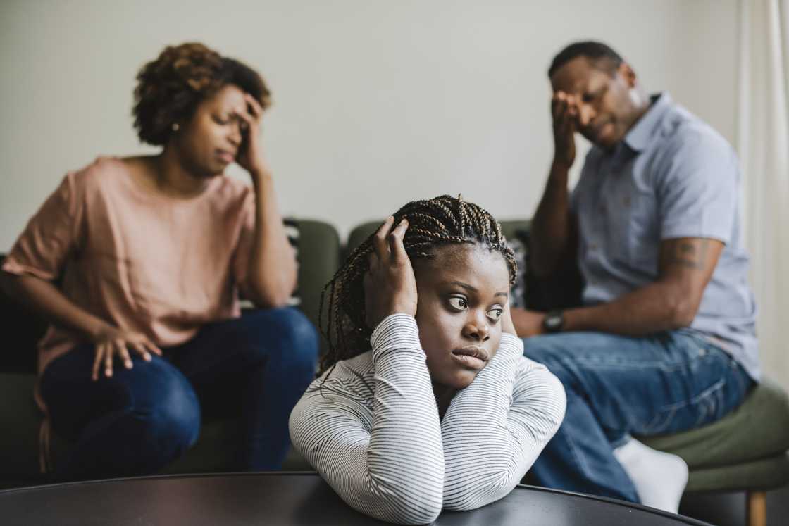 A couple argues infront of a teenage girl