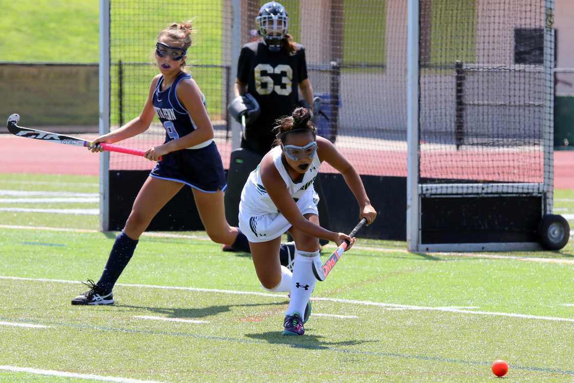 Women playing field hockey Women playing field hockey