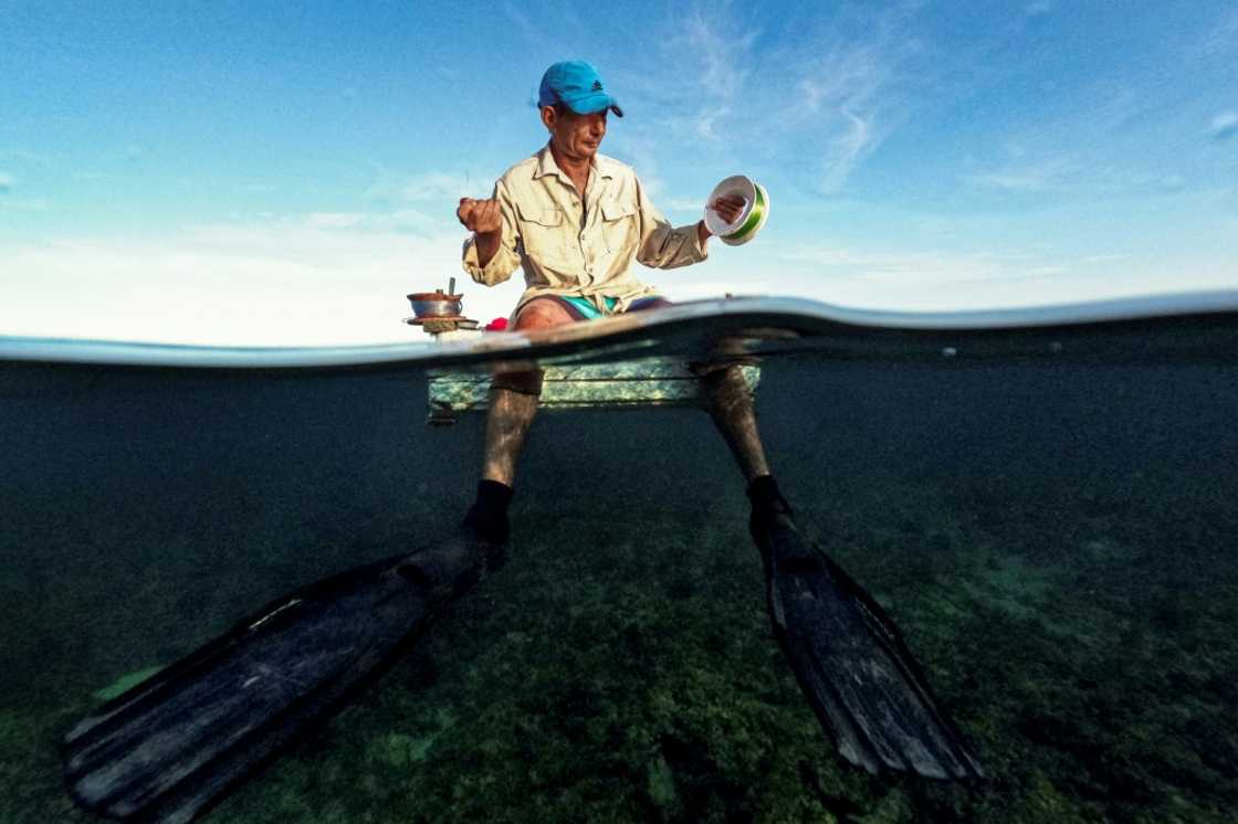 A Cuban fisherman prepares to fish from a makeshift raft in Havana Bay on July 16, 2024 A Cuban fisherman prepares to fish from a makeshift raft in Havana Bay on July 16, 2024