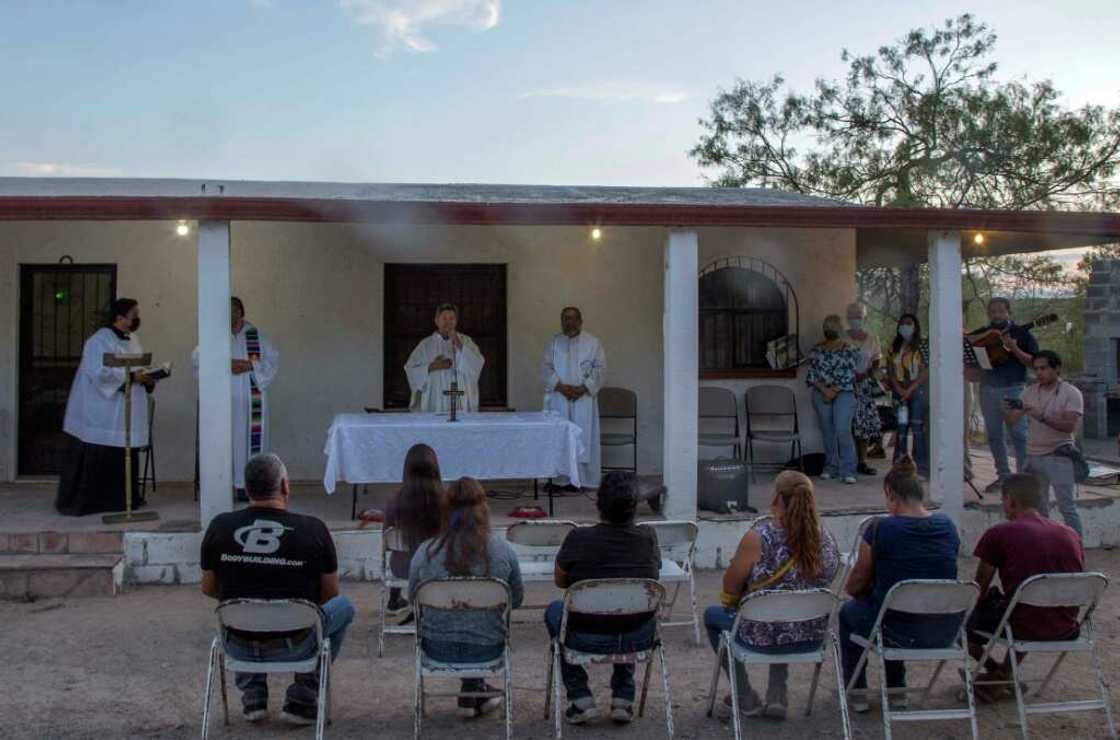 Some of the miners' relatives joined a mass near their improvised camp in the community of Agujita