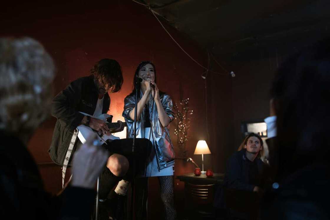 A young lady singing on stage