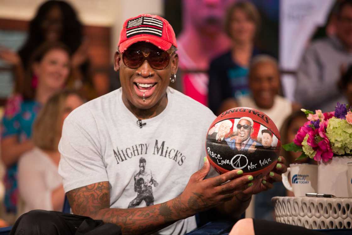 Dennis Rodman poses with a basketball in 2018 Dennis Rodman poses with a basketball in 2018