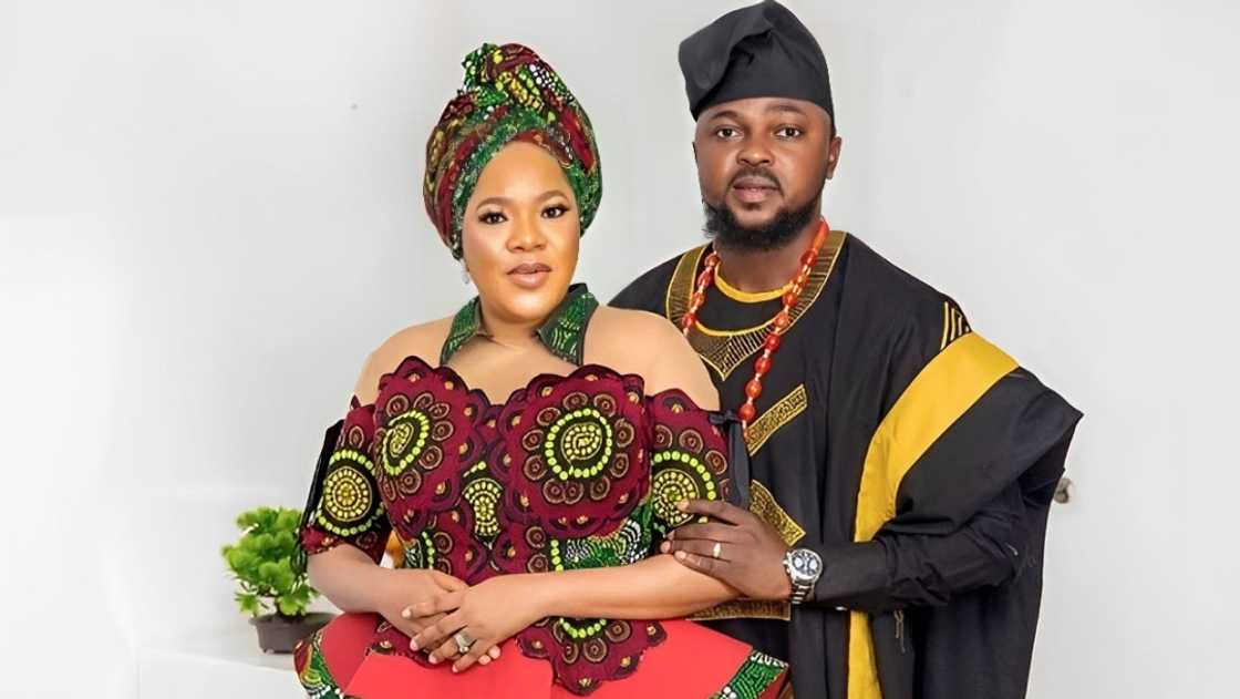Toyin Abraham (L) poses standing with her husband Kolawole Ajeyemi (R) in traditional Yoruba clothes. Toyin Abraham (L) poses standing with her husband Kolawole Ajeyemi (R) in traditional Yoruba clothes.