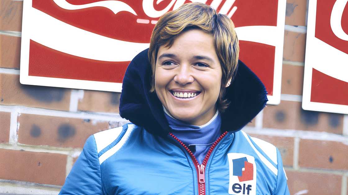 Lella Lombardi smiles standing in font of a wall. Lella Lombardi smiles standing in font of a wall.