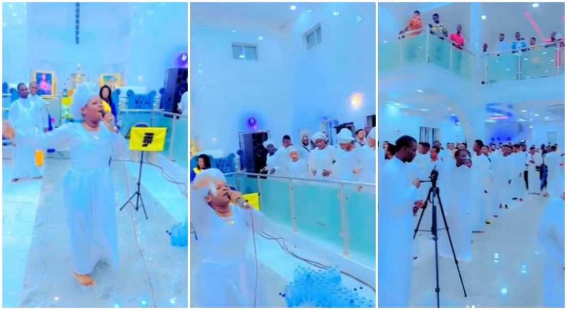 Nigerian church members in white garments sing and dance hard to "Zazu" during church service.