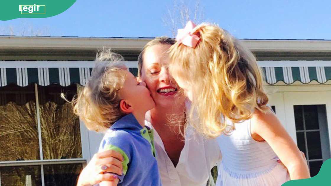 Cora Belle Connelly and her brother embrace their mother