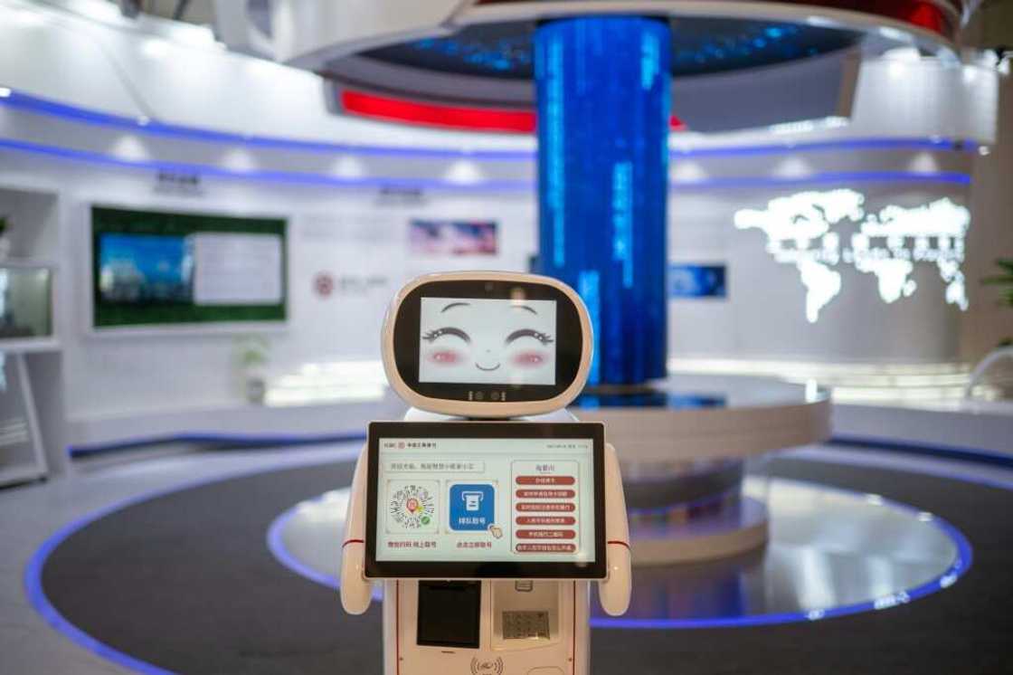 A robot greets visitors at a bank in the Asian Games media centre A robot greets visitors at a bank in the Asian Games media centre