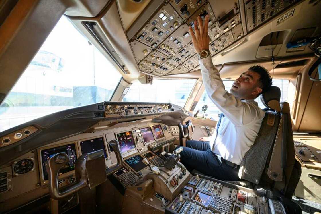 Pilot Omar Morsi checks controls in the cockpit of a United Airlines Boeing 777 aircraft at Newark Liberty International Airport in Newark, New Jersey