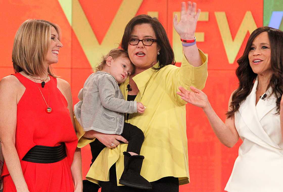 Rosie O'Donnell holds Dakota on stage