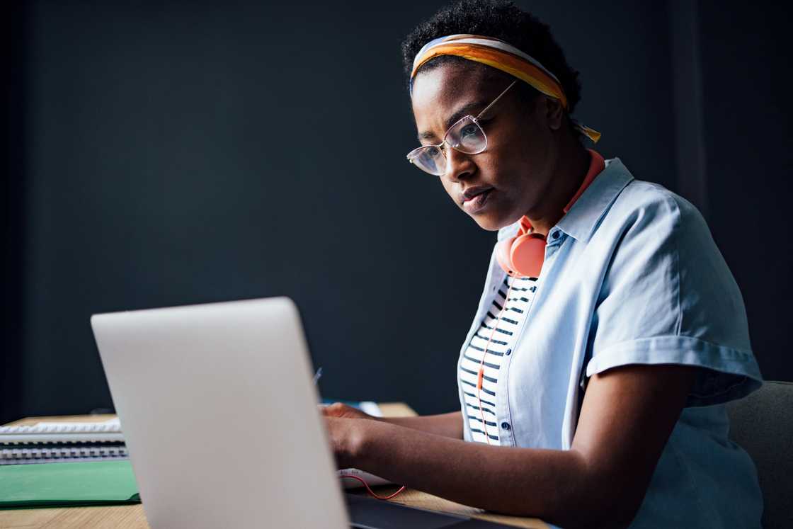 A woman studying using a laptop computer.