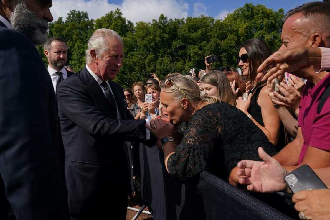 King Charles shook hands, accepted flowers and waved as people held up their phones to take selfies