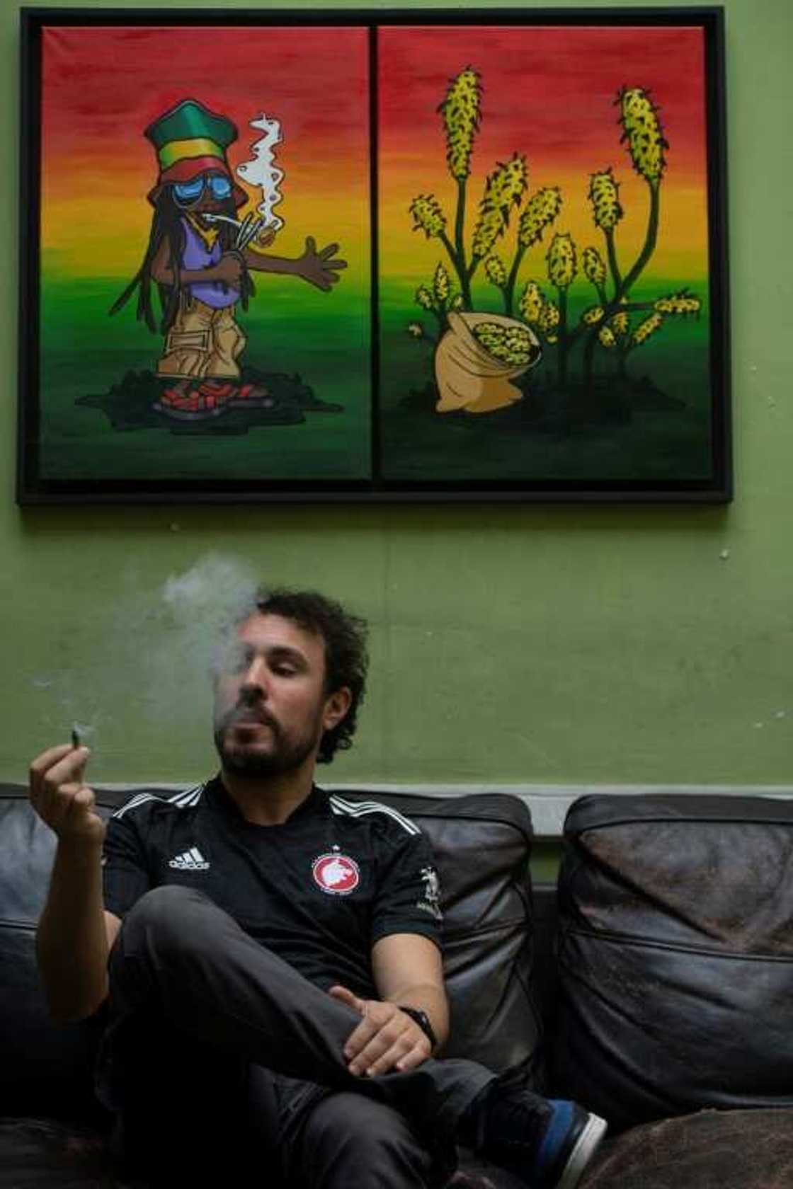 A registered user smokes cannabis at a legal marijuana club in Montevideo A registered user smokes cannabis at a legal marijuana club in Montevideo
