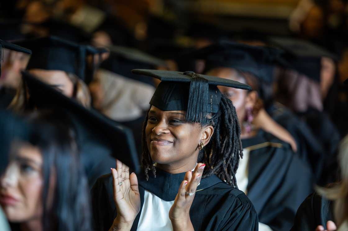 The University of Bradford student clapping during graduation The University of Bradford student clapping during graduation