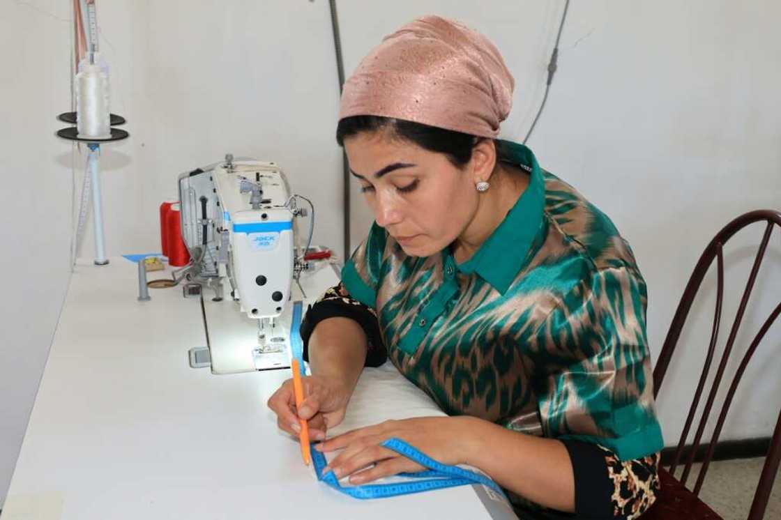 A seamstress works on a silk garment at a Tumush Kola factory in Uzbekistan